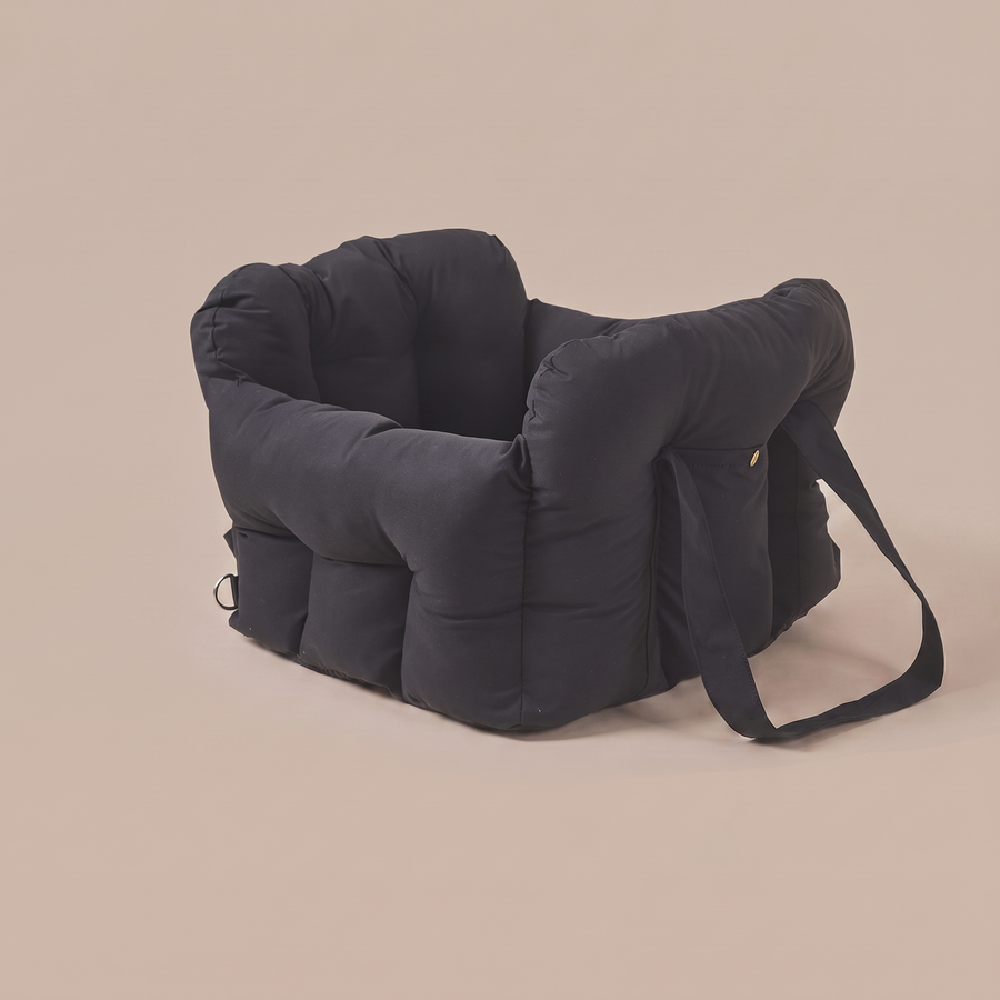 Pawzie Perch dog car booster bed in black, shown on a plain background with its shoulder carry strap
