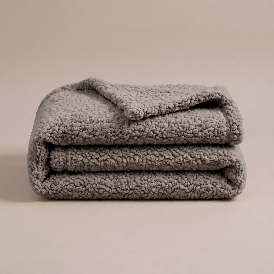 Pawzie Throw plush pet blanket in Gray, folded sherpa fleece on a plain background